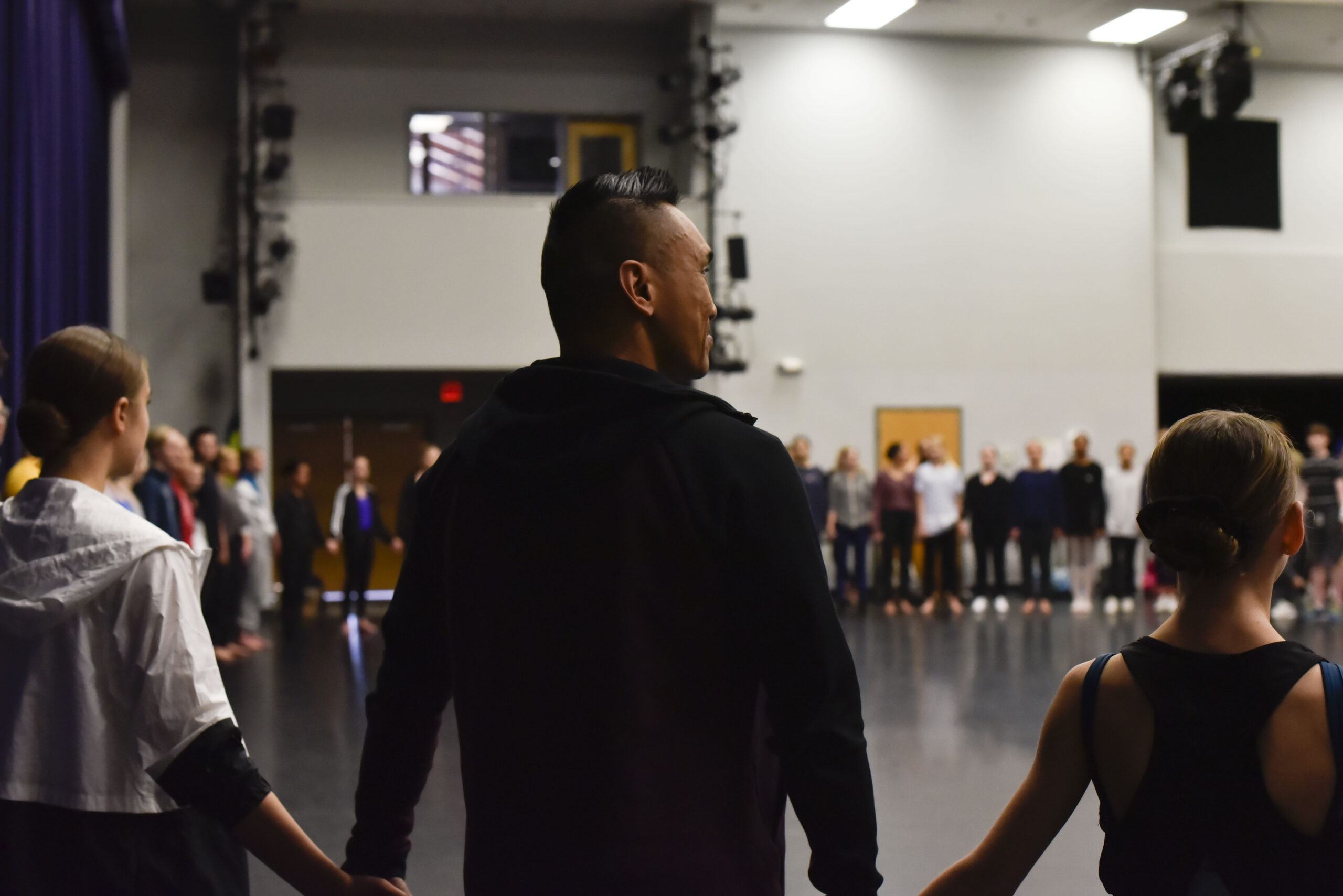 instructors-dancers-holding-hands-in-circle-img